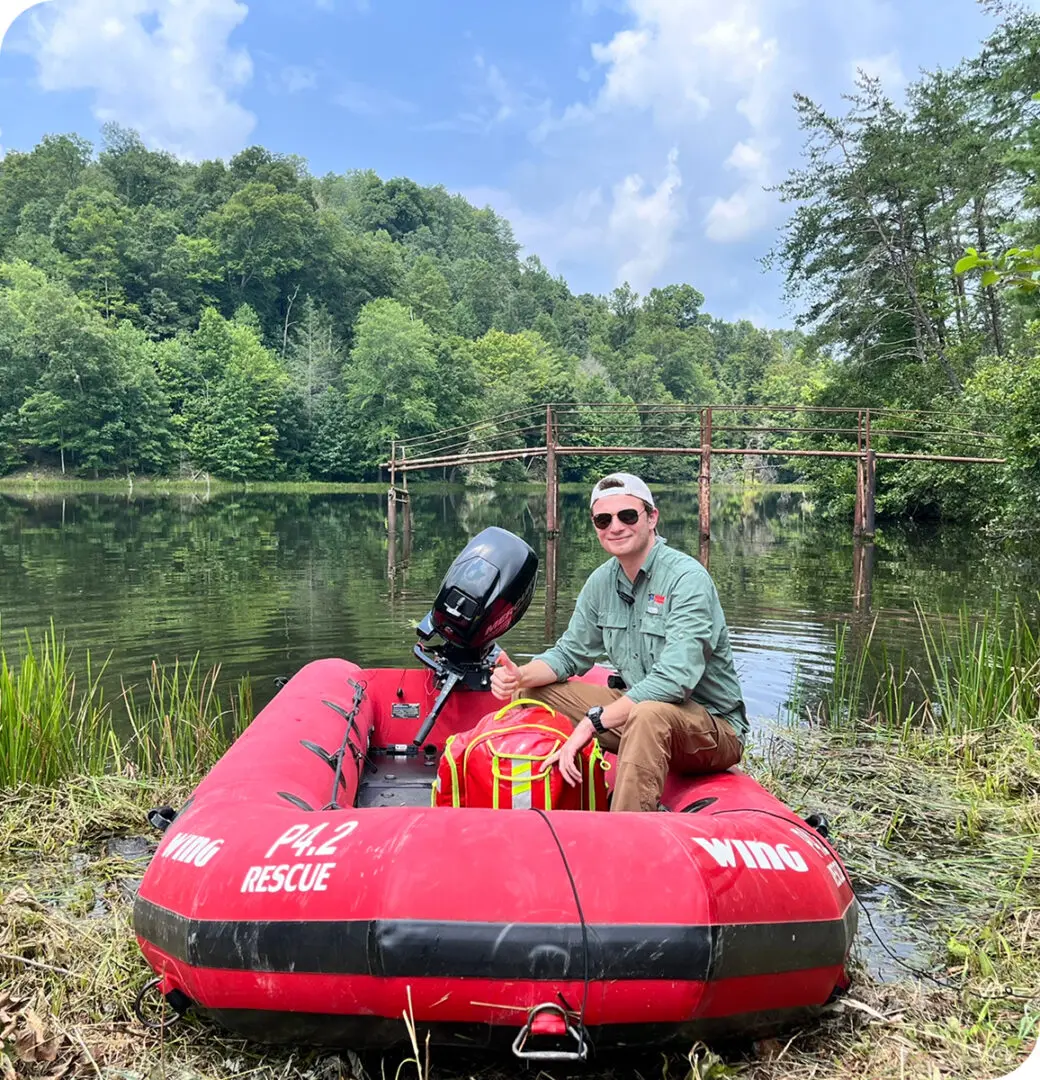 A man sitting in an inflatable boat on the water.