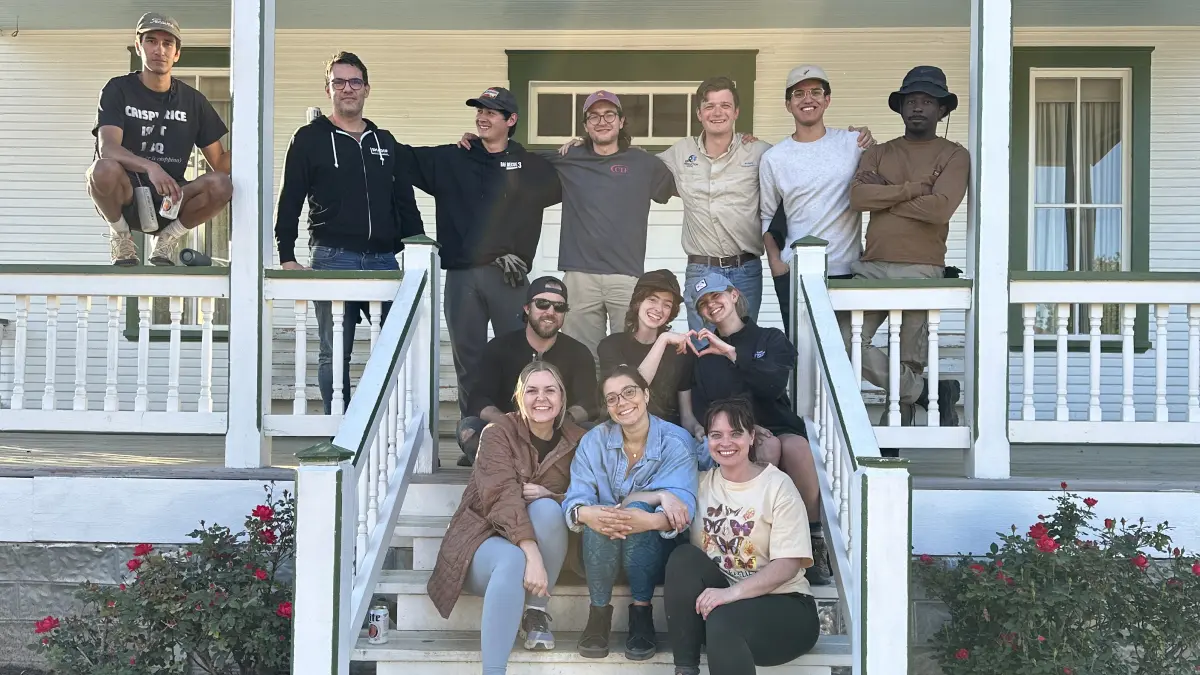 A group of people standing on the steps outside