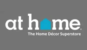 At Home store logo on gray background.